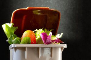 Image of food waste spilling out of a bin.